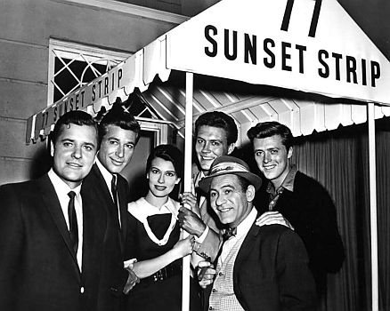"77 Sunset Strip": Szenenfoto mit den Hauptdarstellern (v.l.n.r.): Richard Long (Detektiv Rex Randolph), Efrem Zimbalist Jr. (Detektiv Stuart Bailey), Jacqueline Beer (Sekretärin Suzanne Fabray), Roger Smith (Detektiv Jeff Spencer), Louis Quinn (Pferdewetter Roscoe) und Edward "Edd" Byrnes (Kookie); mit freundlicher Genehmigung von "Pidax Film", welche die legendäre Krimiserie (Volume 1–3) Mitte Mai 2021 auf DVD herausbrachte.