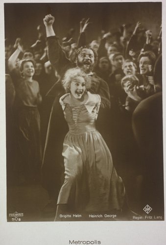 Szenenfoto aus "Metropolis" mit Brigitte Helm und Heinrich George, der den Grot, Wächter der Herz-Maschine, spielte; Foto mit freundlicher Genehmigung der sterreichischen Nationalbibliothek (NB); Urheber/Körperschaft: Künstlerpostkarte im "Ross-Verlag", Berlin; Copyright "Ross.Verlag" / NB Wien; Bildarchiv Austria (Inventarnummer Pf 2580 : C (4))