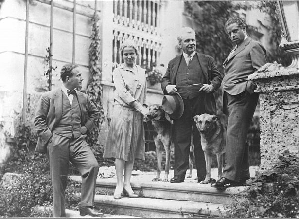 von links nach rechts: Hermann, Helene und Hugo Thimig mit Max Reinhardt sowie zwei Schferhunden um 1935 auf der Treppe vor Schloss Leopoldskron; Foto mit freundlicher Genehmigung der sterreichischen Nationalbibliothek (NB); Autor/Urheber: Hans Bhm; Datierung: um 1935; Copyright Hans Böhm /  NB Wien; Bildarchiv Austria (Inventarnummer NB 612.921 B)