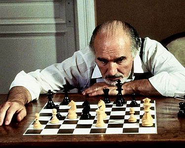 "Gefährliche Züge": Szenenfoto mit Michel Piccoli als Schach-Großmeister Akiva Liebskind; mit freundlicher Genehmigung von Pidax Film, welche den Polit-Thriller Mitte Juli 2025 auf DVD herausbrachte