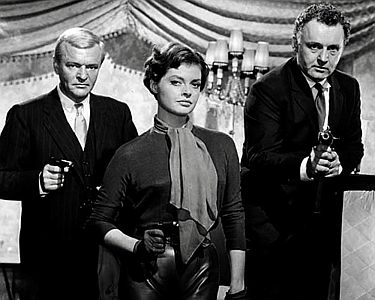 "An einem Freitag um halb zwölf…": Szenenfoto (v.l.n.r.) mit Peter van Eyck als der Kriminelle Bleck, Nadja Tiller als Ginny, Freundin des Gangsters Frank Morgan (Rod Steiger) und Jean Servais als der Kriminelle Gypo; mit freundlicher Genehmigung von Pidax-Film, welche die Produktion Anfang Juni 2020 auf DVD herausbrachte.