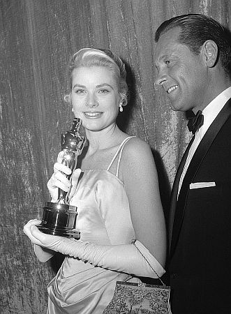 Grace Kelly mit  William Holden anlsslich der 27. "Oscar"-Verleihung am 30. Mrz 1955 im "RKO Pantages Theatre"1) in Los Angeles; Quelle: Wikimedia Commons von "UCLA Library Digital Collection"; Urheber: "Los Angeles Times"; Lizenz: CC BY 4.0 Deed